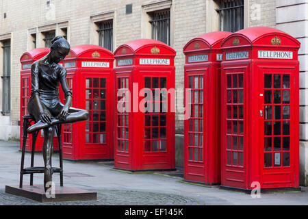 Enzo Plazzotta's statue 'Young Dancer', tribute to Dame Ninette de Valois, with five red telephone boxes or booths, Covent Garden, London Stock Photo