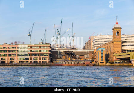 View of Stanhope tower cranes on the London skyline on the Bloomberg Place development site, City of London, EC4 across Vintners Place and Thames Stock Photo
