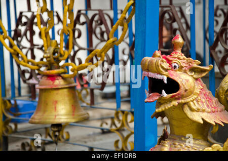 old brass bell and dragon head in asia temple, Nepal Stock Photo
