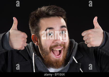 Happy Young Man Showing Thumbs Up Signs Stock Photo