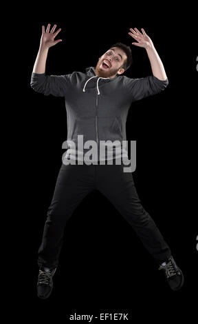 Happy Man in Wacky Pose on Black Background Stock Photo