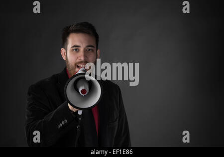 Man in Black Suit Speaking Using Megaphone Stock Photo