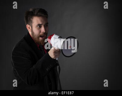 Talking Young Man Using Megaphone Stock Photo