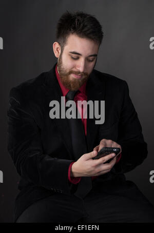 Smiling Man in Formal Attire with Phone Stock Photo