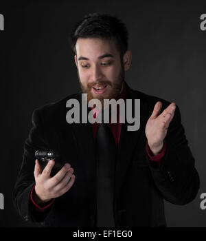 Surprised Businessman Looking at his Phone Stock Photo