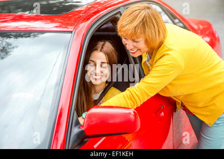 Mother teaching her daughter to drive the car Stock Photo