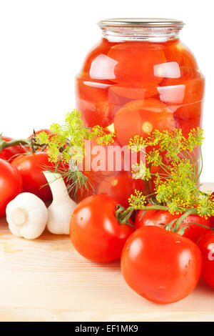 Homemade tomatoes preserves in glass jar. Fresh and canned tomatoes. Stock Photo