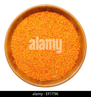 red lentils in wooden bowl, isolated Stock Photo