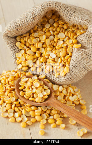 dried peas in hessian bag on kitchen table Stock Photo