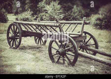 old wooden cart on field, vintage stylized photo Stock Photo