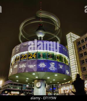 Alexanderplatz, Berlin, Germany. 24th Jan, 2015. A depiction of the solar system on top of the so-called 'Urania-Weltzeituhr' (Urania clock - showing times around the world) spins around leaving traces in the nightly sky in front of the television tower on Alexanderplatz, Berlin, Germany, 24 January 2015. Photo: Paul Zinken/dpa (EDITORIAL NOTE: picture taken with long time exposure)/dpa/Alamy Live News Stock Photo