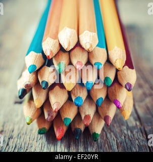Colored drawing pencils closeup on old desk. Vintage stylized image. Stock Photo
