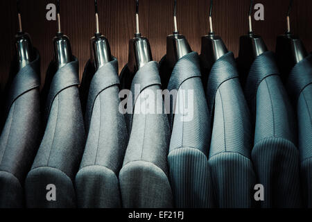 Row of men suit jackets on hangers Stock Photo