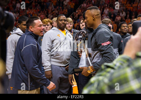 January 24, 2015: Tennessee Volunteers football coach Butch Jones and quarterback Josh Dobbs and teammates show off the TaxSlayer Bowl Trophy during the NCAA basketball game between the University of Tennessee Volunteers and the Texas A&M Aggies at Thompson Boling Arena in Knoxville TN Stock Photo