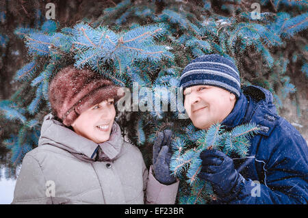 Happy mature couple in winter clothing smiling at camera Stock Photo
