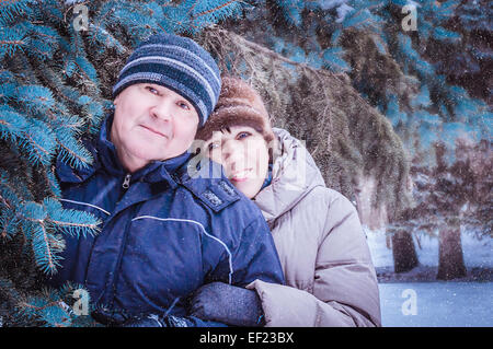 Happy mature couple in winter clothing smiling at camera Stock Photo