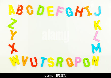 Frame of Colorful alphabet magnets on a whiteboard Stock Photo