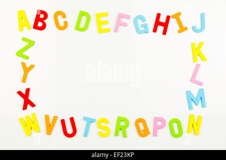 Frame of Colorful alphabet magnets on a whiteboard Stock Photo
