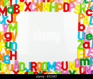 Frame of Colorful alphabet magnets on a whiteboard Stock Photo
