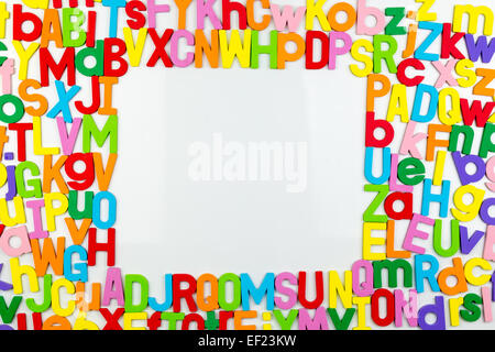 Frame of Colorful alphabet magnets on a whiteboard Stock Photo