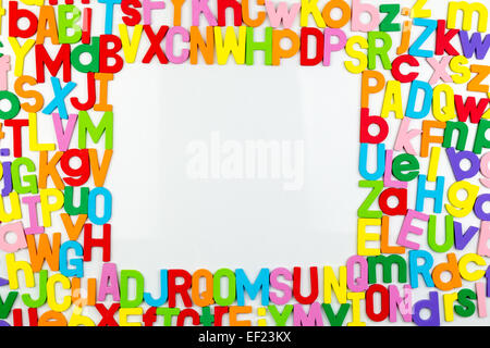 Frame of Colorful alphabet magnets on a whiteboard Stock Photo