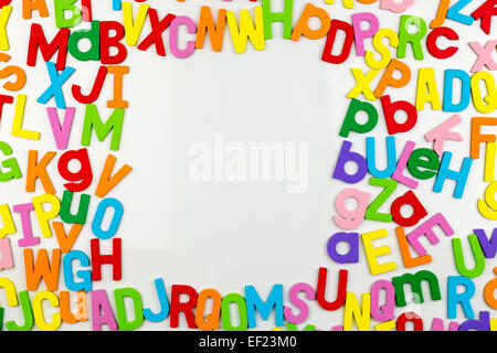 Frame of Colorful alphabet magnets on a whiteboard Stock Photo