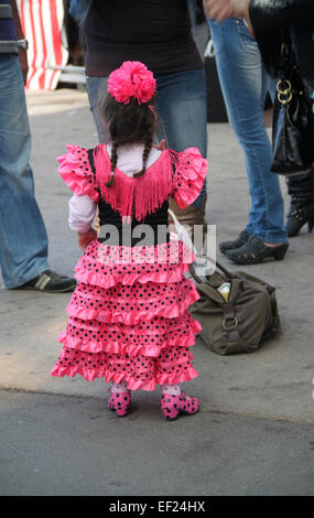 Young girl in traditional Spanish flamenco dress at the Feria de Abril de Catalonia (April Fair of Catalonia) in Barcelona Stock Photo