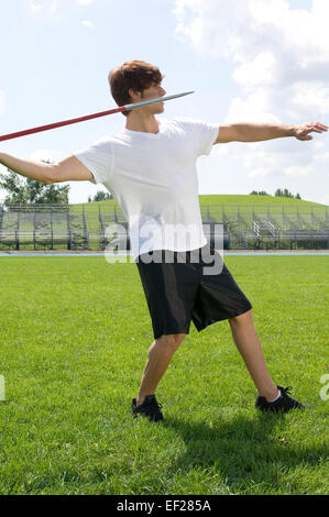 Man with javelin on field Stock Photo