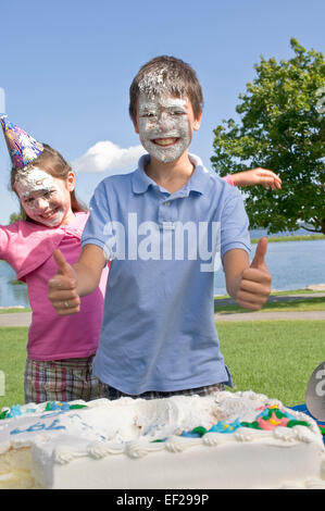 Children with icing on their faces Stock Photo