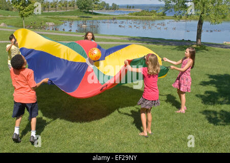 Children Playing With A Parachute Stock Photo - Alamy