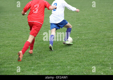 Soccer or football players in action on the field, blurred in motion Stock Photo