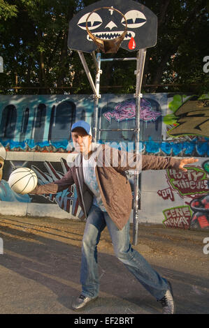 Teenage boy playing basketball Stock Photo