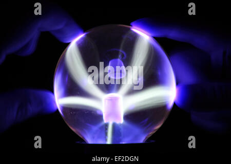 Blue Magical sphere in wizard hand on black background Stock Photo