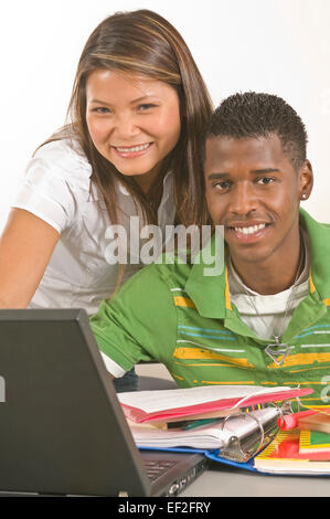 Two students in a classroom with a laptop Stock Photo