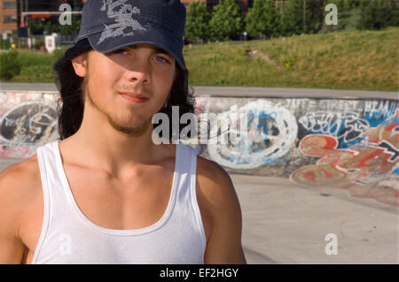 Skateboarder hanging around at a skate park Stock Photo