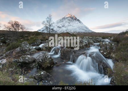 Snow dusted Stob Dearg, Buachaille Etive Mor, and waterfalls on the River Coupall, Glencoe, Scotland Stock Photo