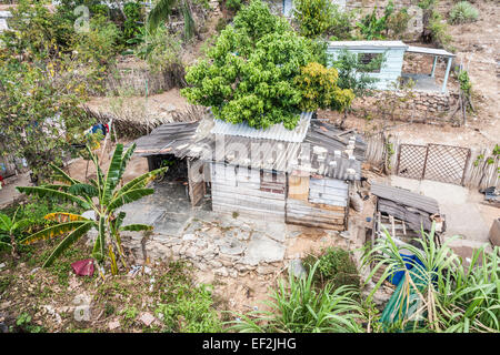 Cuban poverty local lifestyle: typical dilapidated, ramshackle hut with corrugated iron roof in a poor village near Trinidad, Cuba Stock Photo