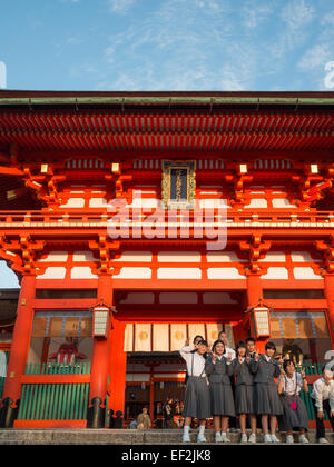 Japanese students group taking a picture in front of Fushimi-Inari-Taisha temple main building Stock Photo