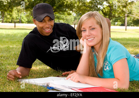 Young man and woman outdoors studying Stock Photo