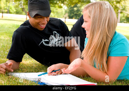 Young man and woman outdoors studying Stock Photo