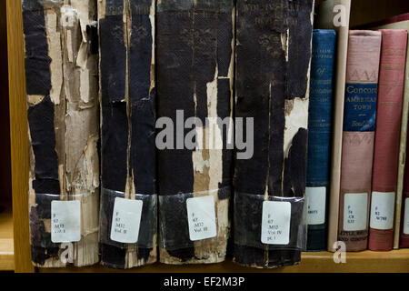 Frayed spine of old books on library shelf - USA Stock Photo