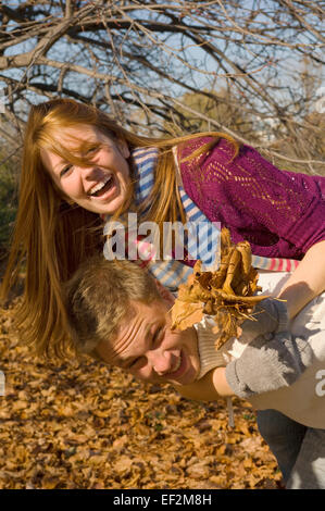 Couple in a park piggybacking Stock Photo