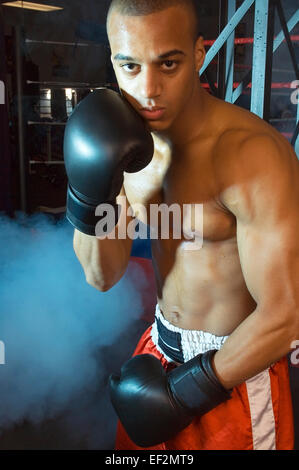 Boxer in gym posing Stock Photo