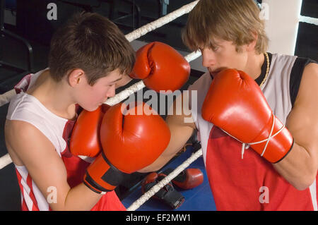 Two boxers in gym having a boxing match Stock Photo