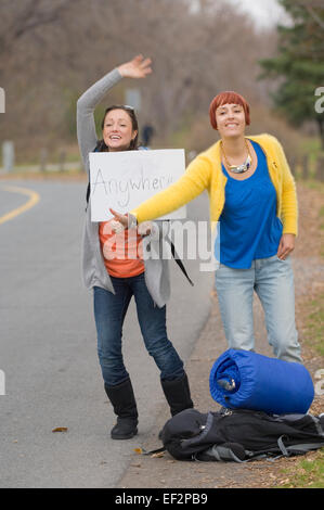 Two women hitchhiking Stock Photo