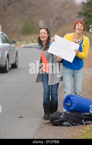 Two women hitchhiking Stock Photo