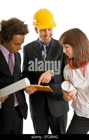 Three people looking at a clipboard Stock Photo