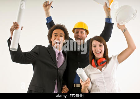 Three excited business people cheering Stock Photo