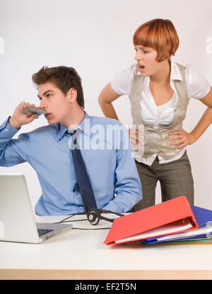 Businessman drinking from a flask while at work Stock Photo