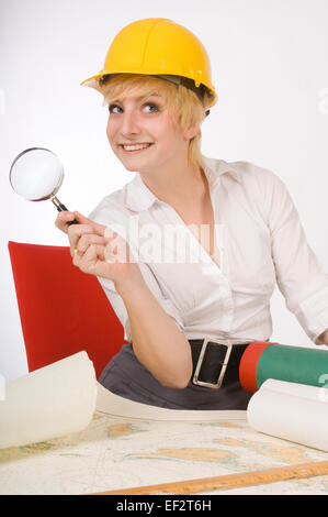 Woman holding magnifying glass while looking at map Stock Photo